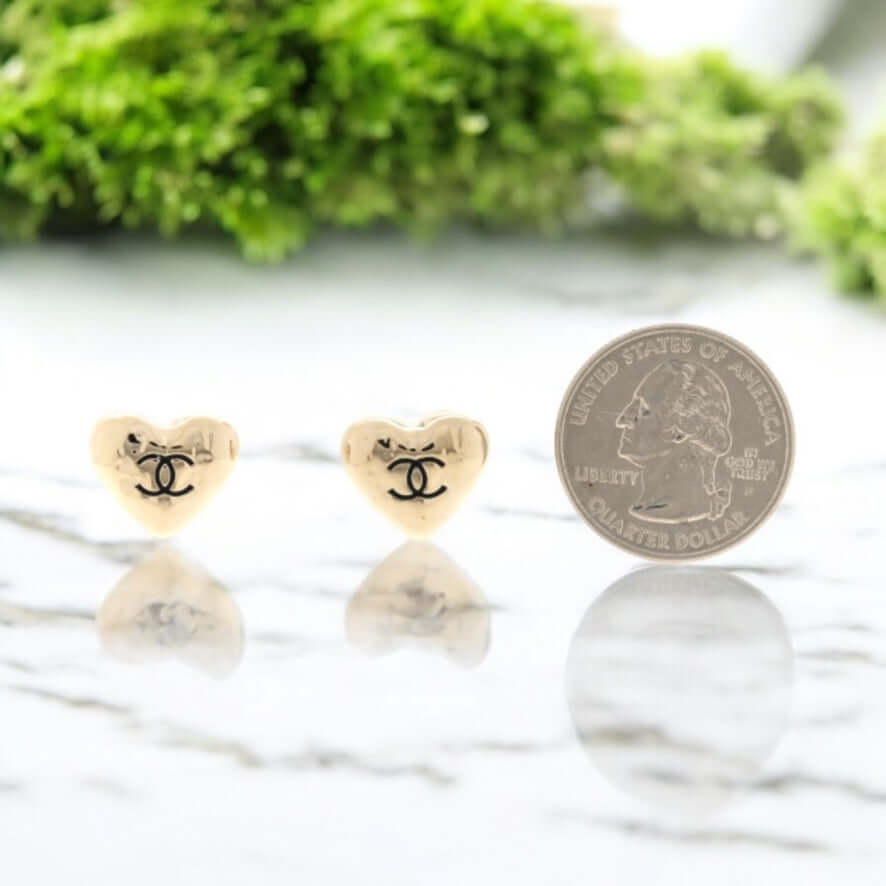 Authentic Chanel gold puffy heart earrings with black enamel CC, shown next to a quarter for scale. My Mama Found What
