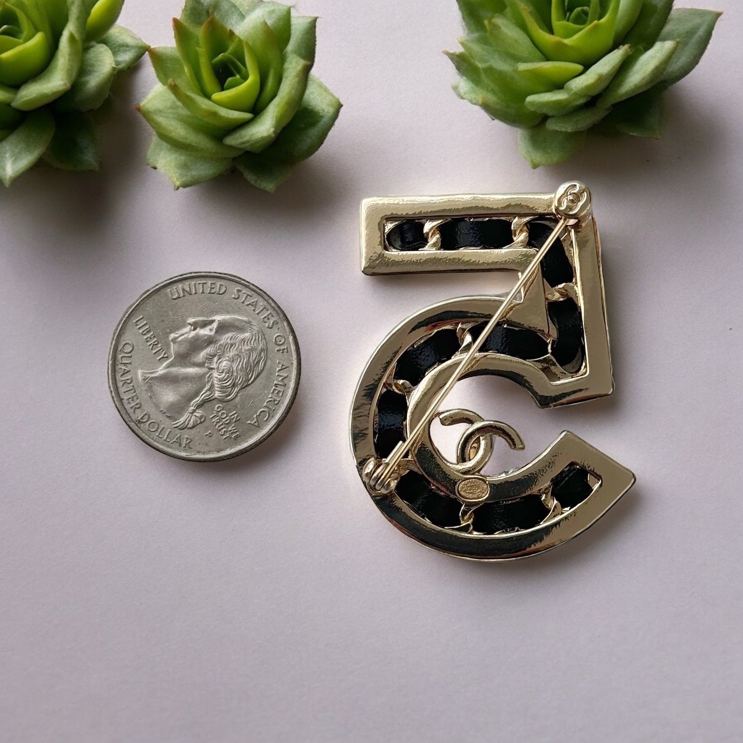 Chanel Gold Number 5 with Double C, Black Leather & CrystalsExperience the height of luxury and chic with this Chanel Gold Number 5 with Double C, Black Leather & Crystals. Inspired by the iconic Number 5 perfume symbol, this rare and like-new bag showcas My Mama Found What