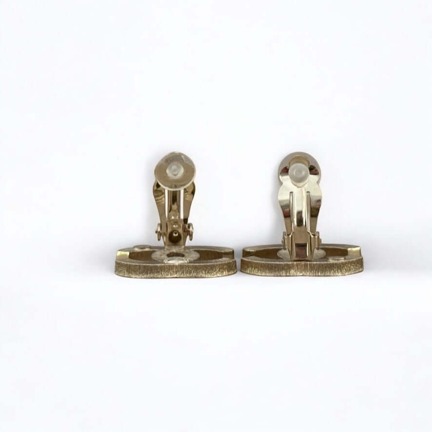 Authentic Chanel CC Lighter Gold clip-on earrings showing detailed back view in excellent pre-owned condition.