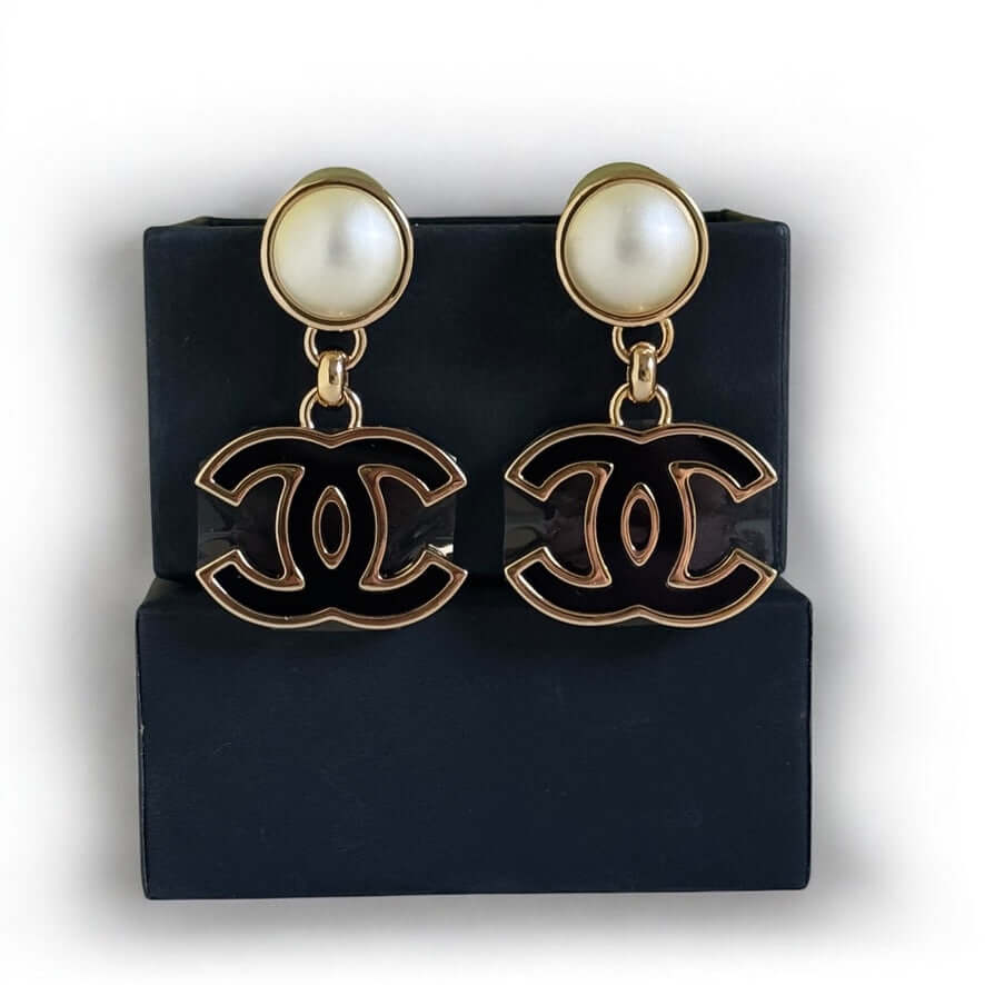 Authentic Chanel CC Gold White Black Dangle Earrings in like new condition, displayed in a gift box.