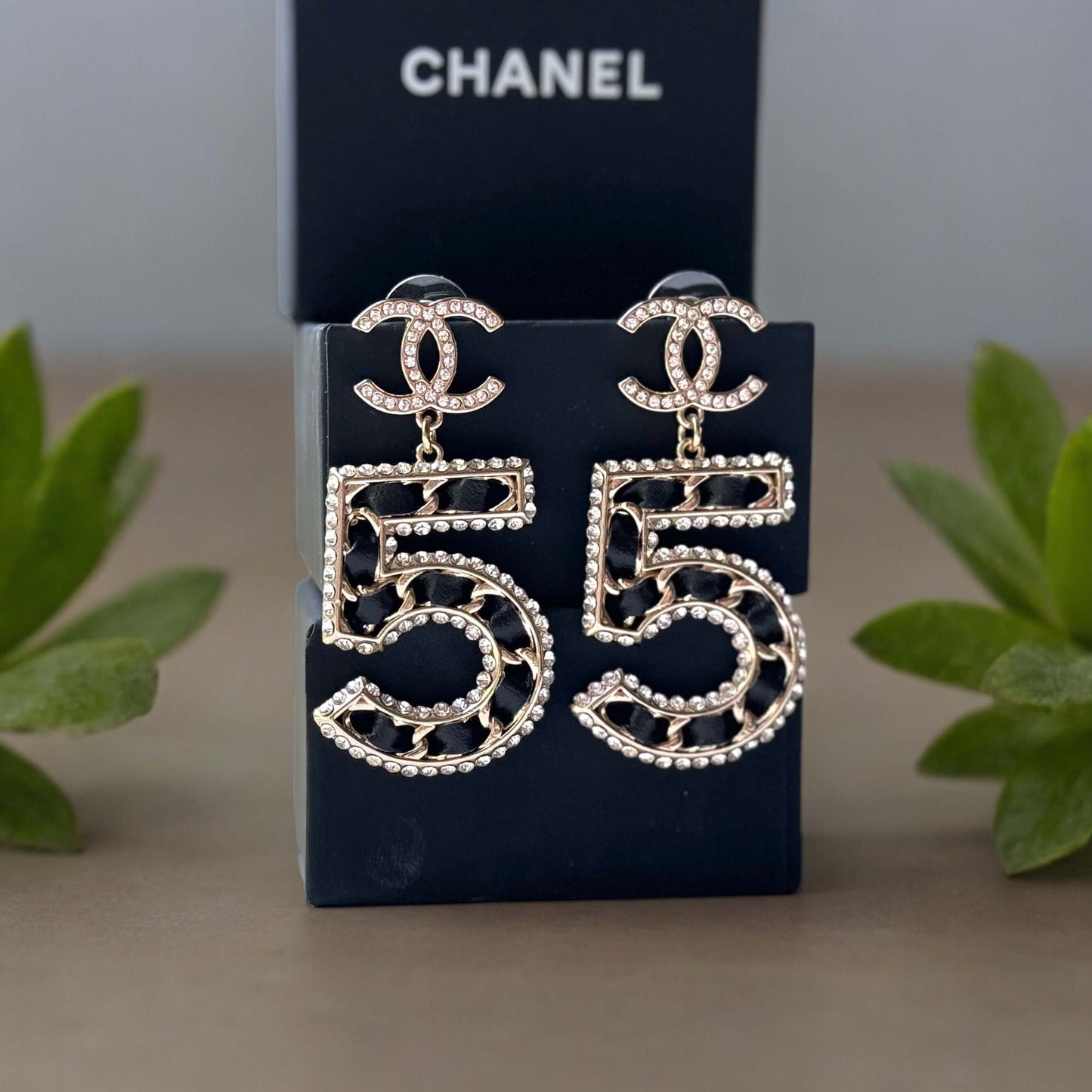 Chanel Gold Number 5 Big Dangle CC EarringsMake a statement with these iconic Chanel Gold Number 5 Big Dangle CC Earrings. The perfect addition to any outfit, these trendy and luxurious earrings feature gold plating, clear crystals, and a bold Chanel No.