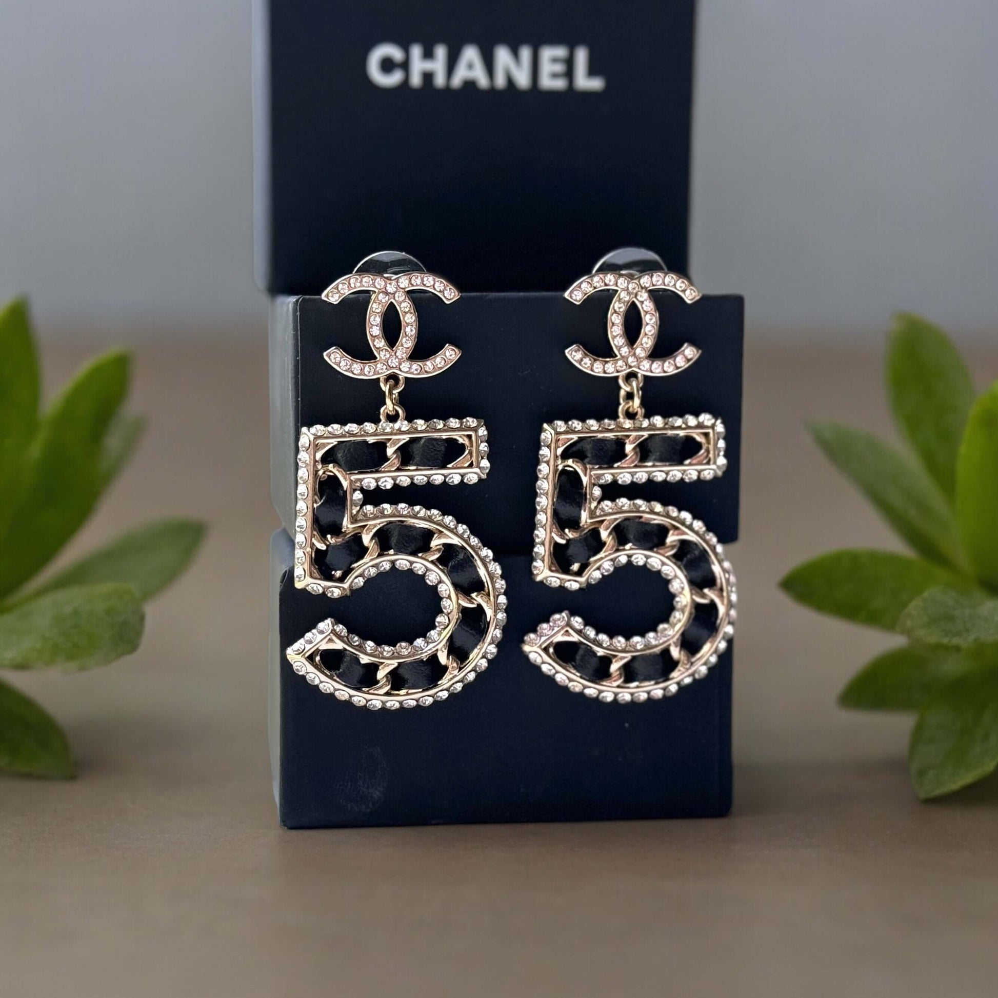 Chanel Gold Number 5 Big Dangle CC EarringsMake a statement with these iconic Chanel Gold Number 5 Big Dangle CC Earrings. The perfect addition to any outfit, these trendy and luxurious earrings feature gold plating, clear crystals, and a bold Chanel No.