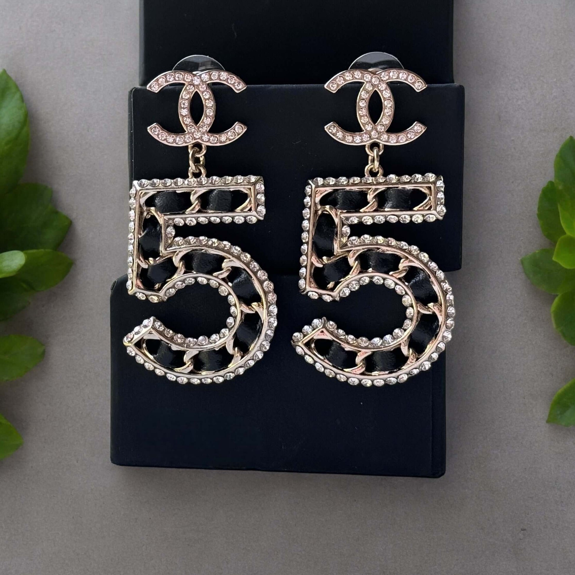 Chanel Gold Number 5 Big Dangle CC EarringsMake a statement with these iconic Chanel Gold Number 5 Big Dangle CC Earrings. The perfect addition to any outfit, these trendy and luxurious earrings feature gold plating, clear crystals, and a bold Chanel No.