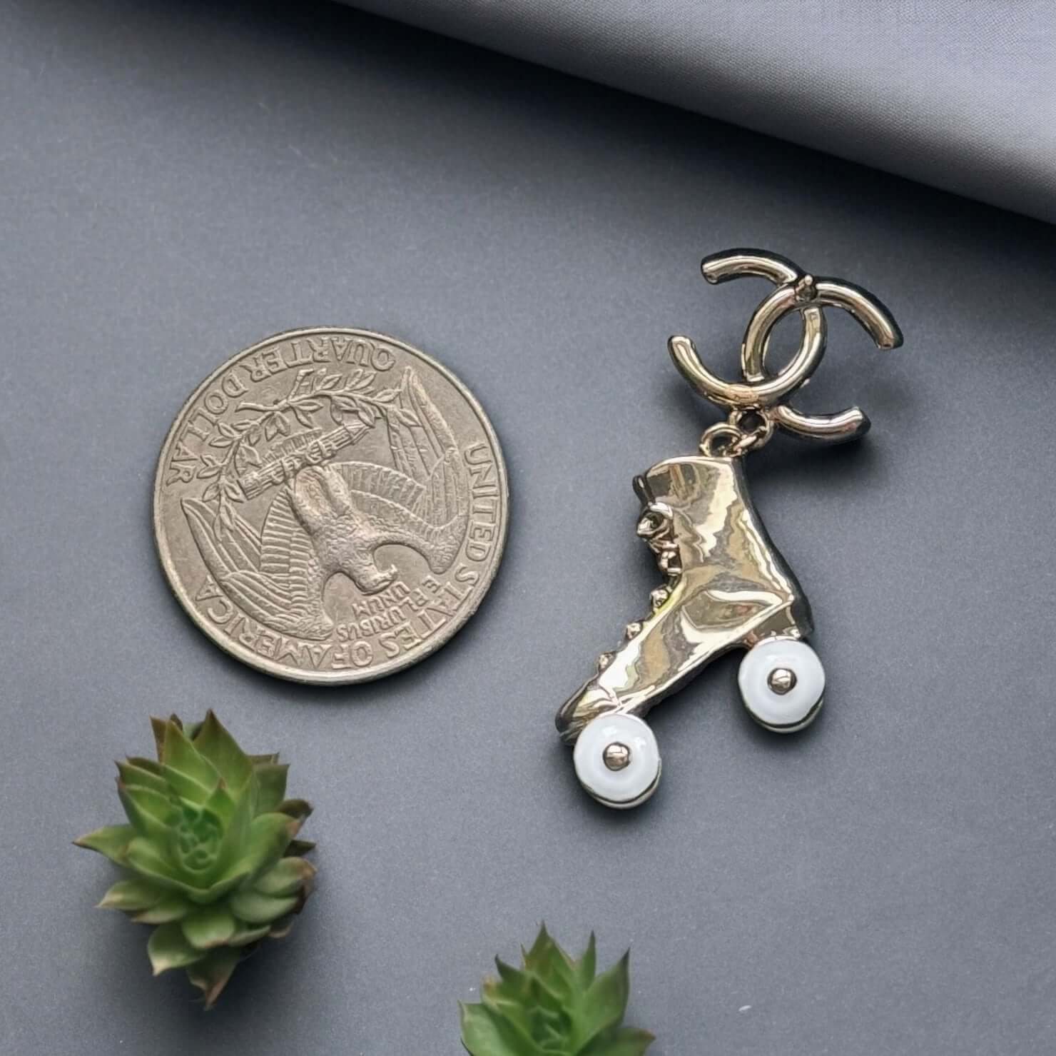 Chanel 14K Gold Tone Double C RARE Funky Rollar Skates Dangling EarringsRARE Hard To Find Unleash your fierce inner rockstar with these rare Chanel 14K Gold Tone Double C Dangling Earrings! Plated in 14k gold, the funky rollar skates with white enamel whe