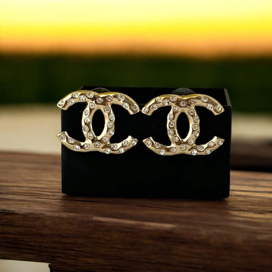 Authentic Chanel Gold CC earrings with crystals in like-new condition, perfect for a luxurious statement accessory.