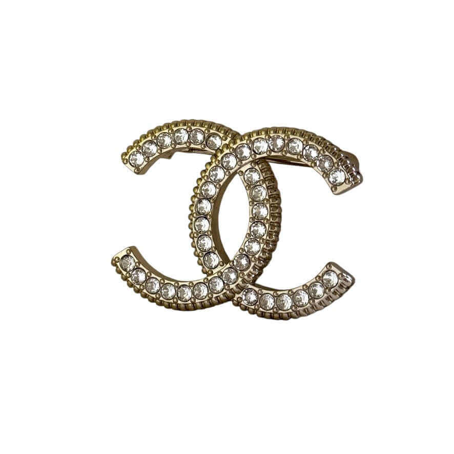 Authentic CHANEL Lighter Gold CC Brooch with sparkling crystals, pre-owned, like new condition, elegant accessory.