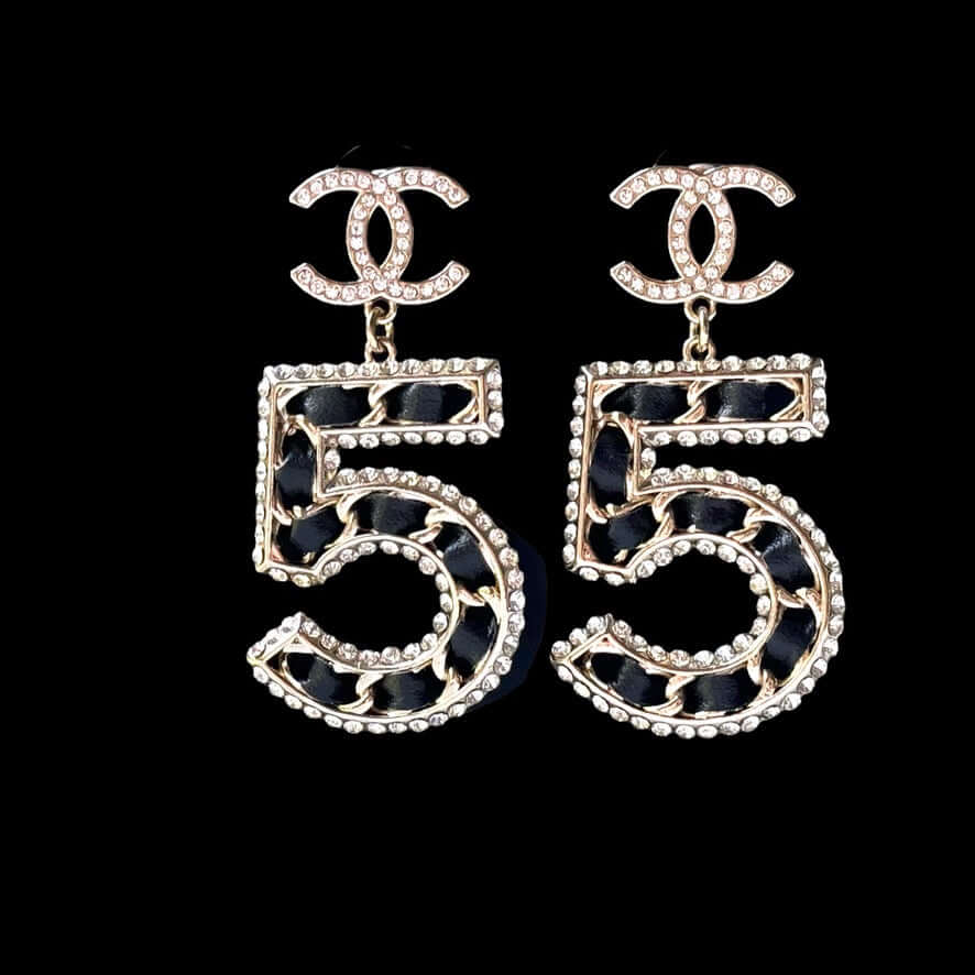 Chanel Gold Number 5 Big Dangle CC EarringsMake a statement with these iconic Chanel Gold Number 5 Big Dangle CC Earrings. The perfect addition to any outfit, these trendy and luxurious earrings feature gold plating, clear crystals, and a bold Chanel No.