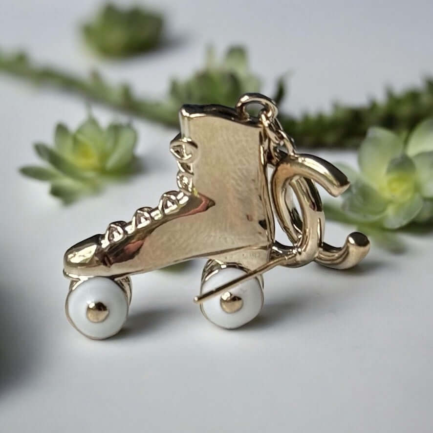 Chanel 14K Gold Tone Double C RARE Funky Rollar Skates Dangling EarringsRARE Hard To Find Unleash your fierce inner rockstar with these rare Chanel 14K Gold Tone Double C Dangling Earrings! Plated in 14k gold, the funky rollar skates with white enamel whe