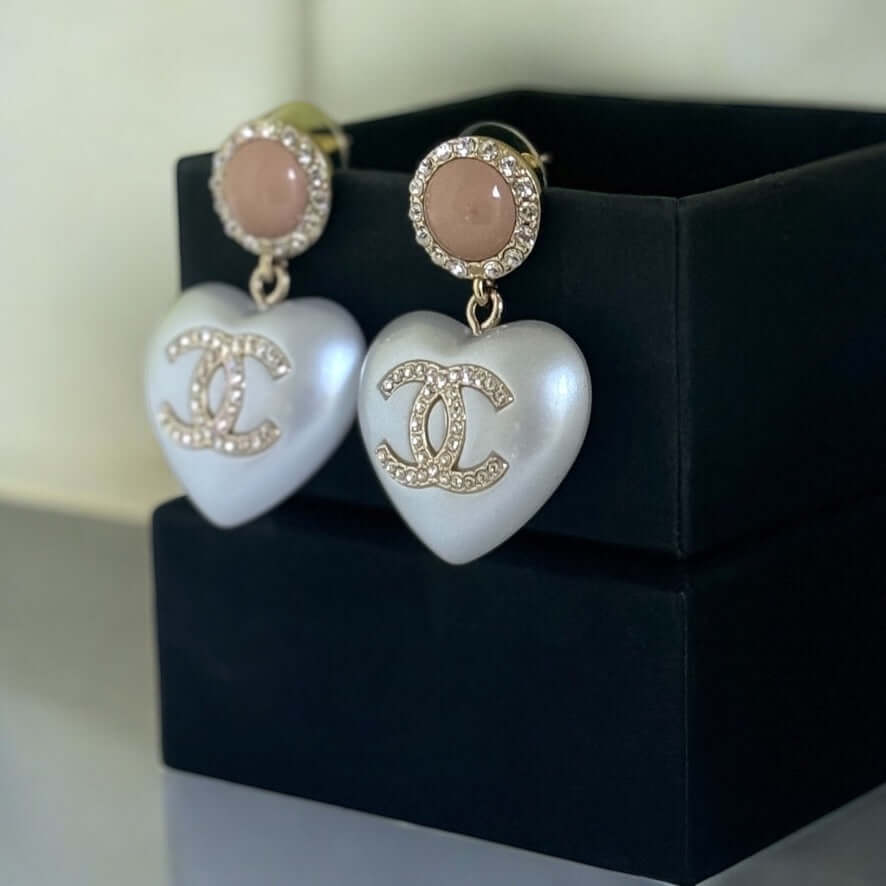 Rare Authentic Chanel CC Pink/White Heart Dangle Earrings Pre-Owned in great condition, showcasing classic and playful design.