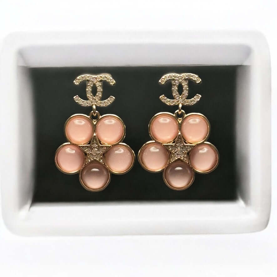 Authentic CHANEL CC Lighter Gold Stars Pink Dangle Earrings in excellent pre-owned condition, beautifully displayed in a gift box.