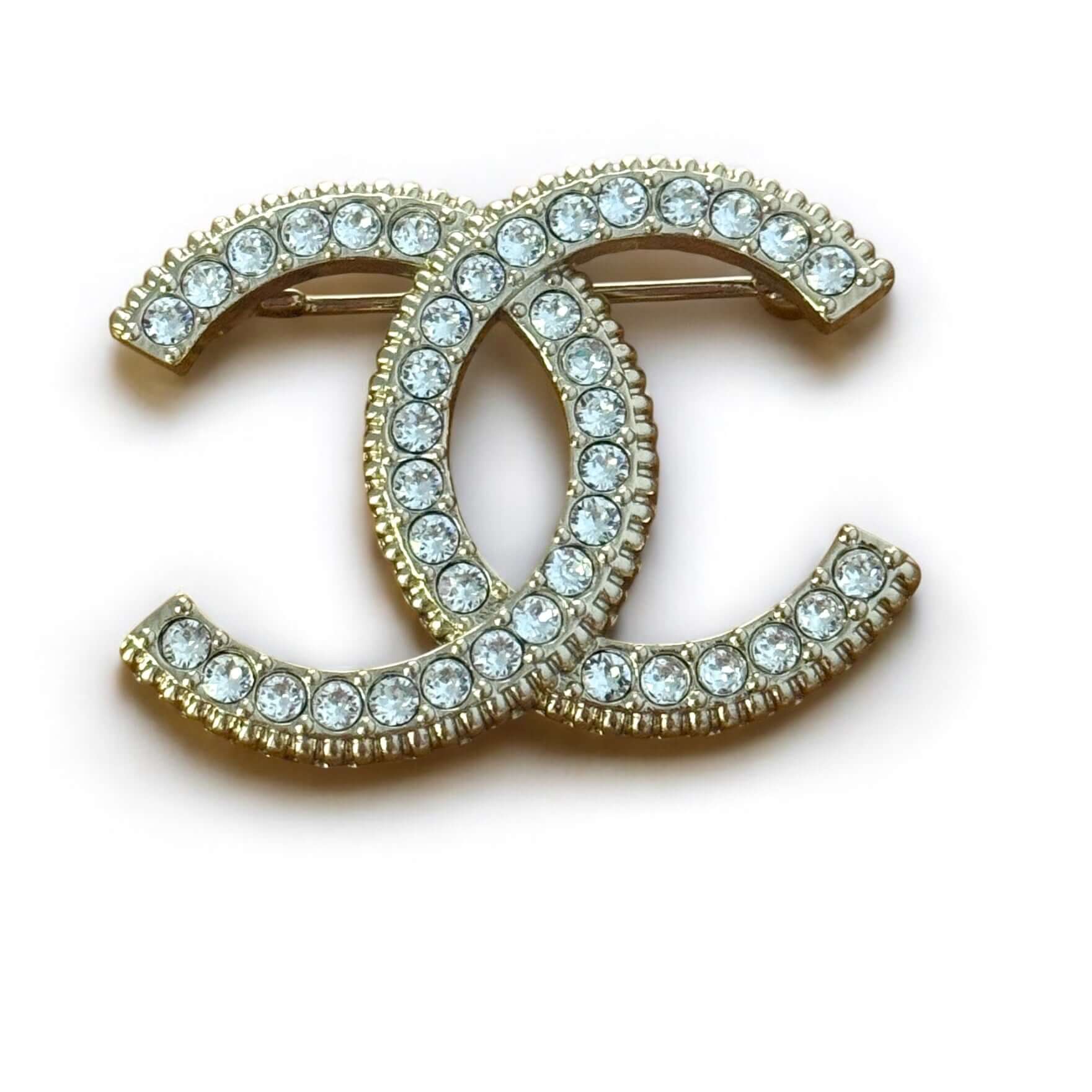 Stunning CHANEL Lighter Gold CC brooch adorned with clear crystals, perfect for year-round style, day or night.