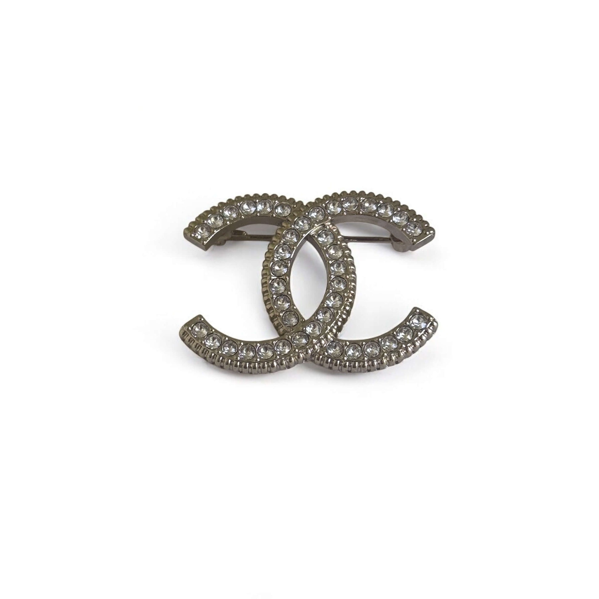 Stunning CHANEL Lighter Gold CC brooch adorned with crystals, perfect for year-round wear day or night.