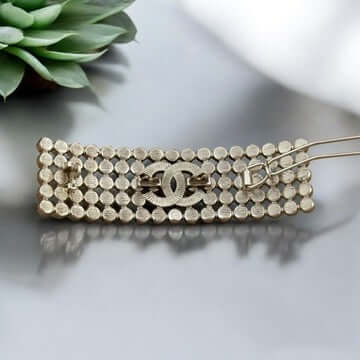 Chanel CC Gold Crystals Barette with iconic gold plating and sparkling crystals, showcasing luxury and style.