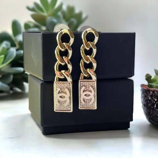 Chanel Gold Plated Chain Double C crystals Dangle EarringsAdd some rockstar flair to your wardrobe with these show-stopping Chanel Gold Plated Chain Double C crystals Dangle Earrings. The double C design and dangling movement make a statement that can't b