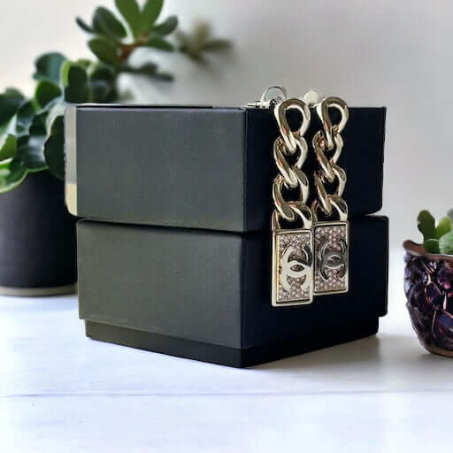 Chanel Gold Plated Chain Double C crystals Dangle EarringsAdd some rockstar flair to your wardrobe with these show-stopping Chanel Gold Plated Chain Double C crystals Dangle Earrings. The double C design and dangling movement make a statement that can't b