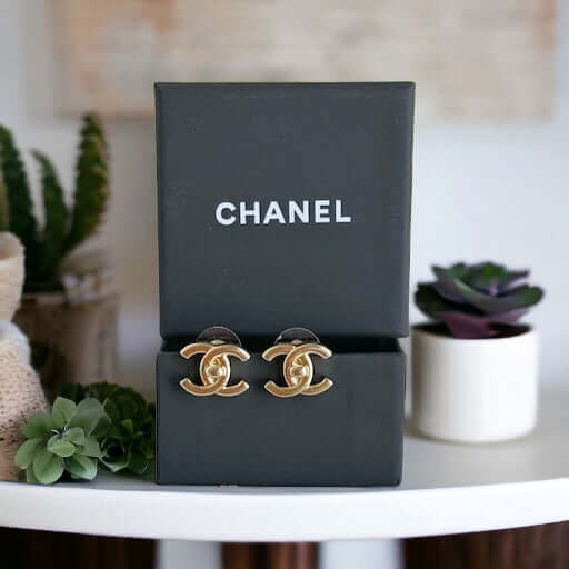 Chanel Gold Double C Lock Post EarringsIndulge in sophistication with our Chanel Gold Double C Lock Post Earrings. Crafted in 14K gold tone, these iconic and elegant earrings are the epitome of luxury. The double C lock style, made in Italy, adds a touch My Mama Found What 
