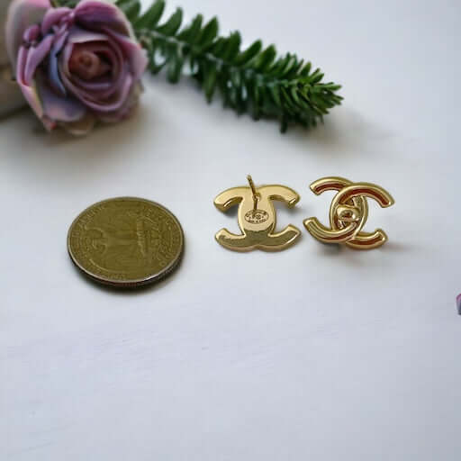 Chanel Gold Double C Lock Post EarringsIndulge in sophistication with our Chanel Gold Double C Lock Post Earrings. Crafted in 14K gold tone, these iconic and elegant earrings are the epitome of luxury. The double C lock style, made in Italy, adds a touch My Mama Found What 