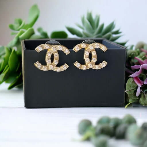 Chanel Gold Double C with raised clear Crystals Post EarringsThese Chanel Gold Double C earrings feature a rare design with clean style and a rock star appeal. The raised clear crystals add a touch of sparkle to these chic accessories. Crafted with gold, My Mama Found What 