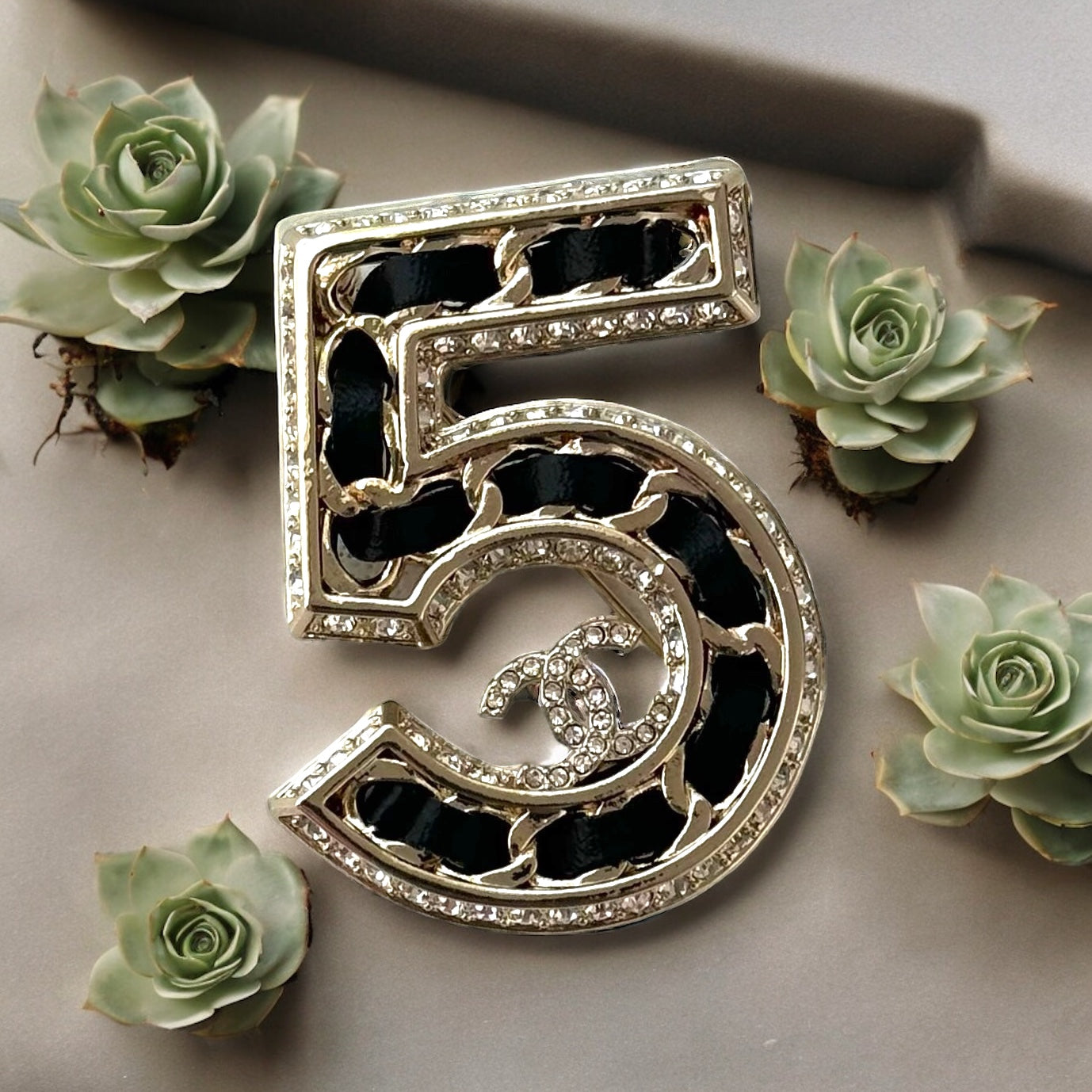 Chanel Gold Number 5 with Double C, Black Leather & CrystalsExperience the height of luxury and chic with this Chanel Gold Number 5 with Double C, Black Leather & Crystals. Inspired by the iconic Number 5 perfume symbol, this rare and like-new bag showcas My Mama Found What 