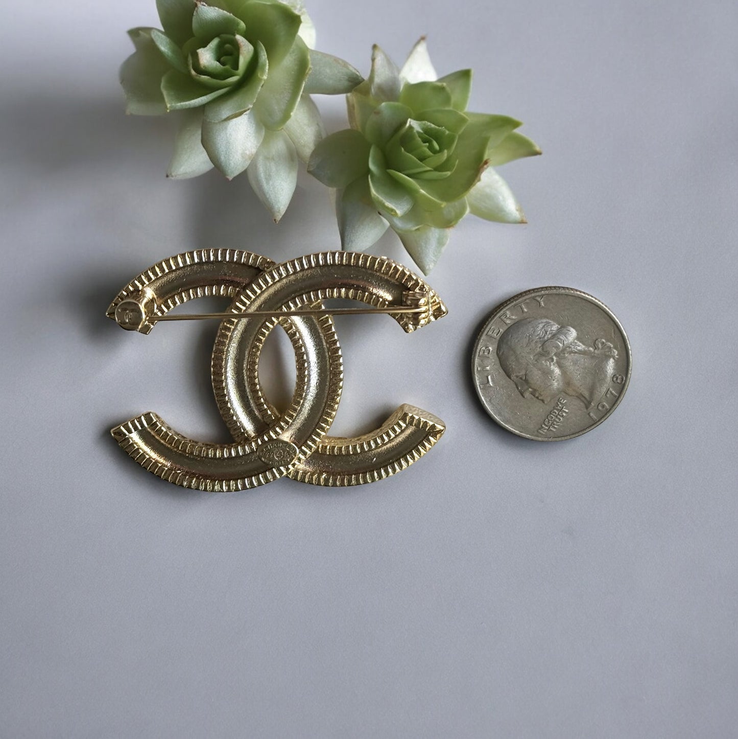 Chanel Gold Plated Textured Double C Brooch PinGorgeous , Ageless , Timeless , Extra Comes with the Chanel Box & Bag Add some whimsy to your outfit with this Chanel Gold Textured Double C Brooch Pin. This playful accessory features a unique textured desig My Mama Found What 