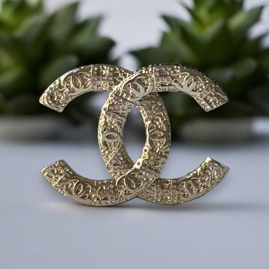 Chanel Gold Plated Textured Double C Brooch PinGorgeous , Ageless , Timeless , Extra Comes with the Chanel Box & Bag Add some whimsy to your outfit with this Chanel Gold Textured Double C Brooch Pin. This playful accessory features a unique textured desig My Mama Found What 