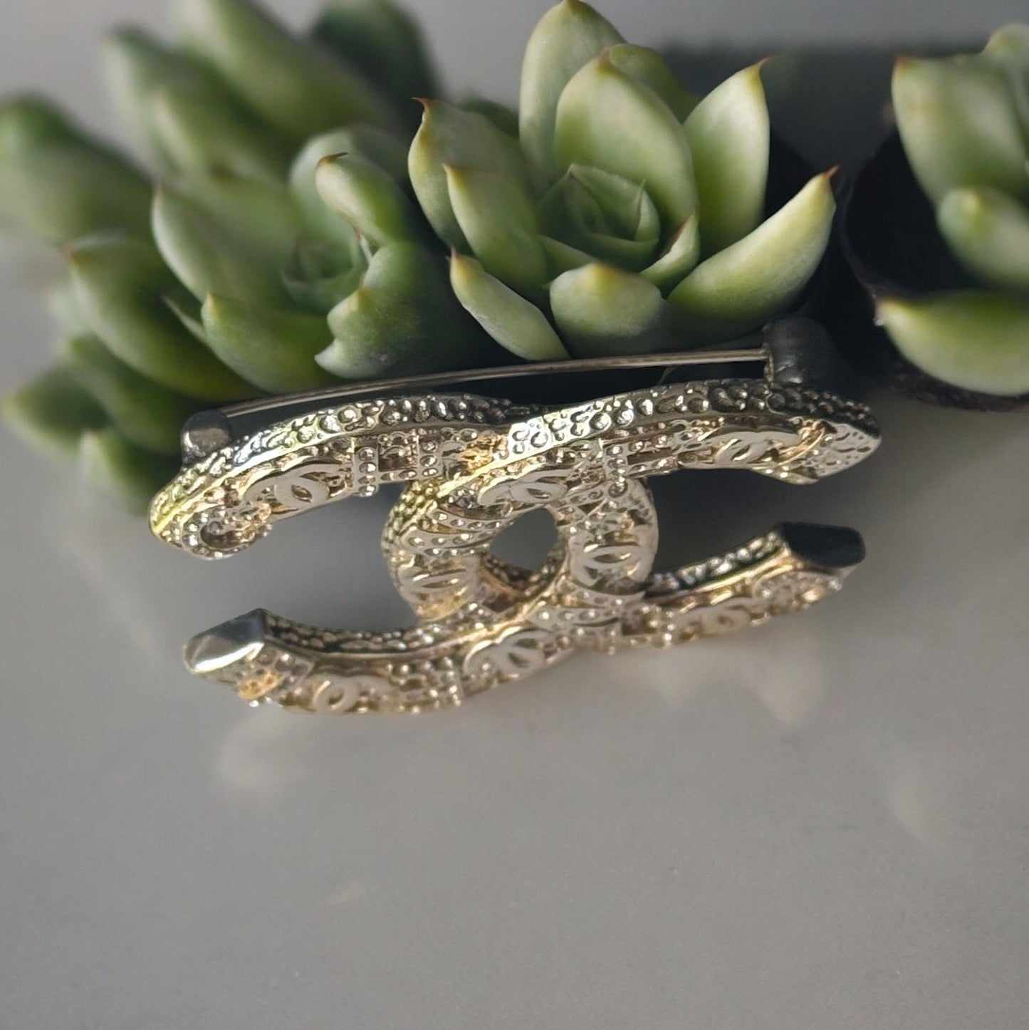 Chanel Gold Plated Textured Double C Brooch PinGorgeous , Ageless , Timeless , Extra Comes with the Chanel Box & Bag Add some whimsy to your outfit with this Chanel Gold Textured Double C Brooch Pin. This playful accessory features a unique textured desig My Mama Found What 
