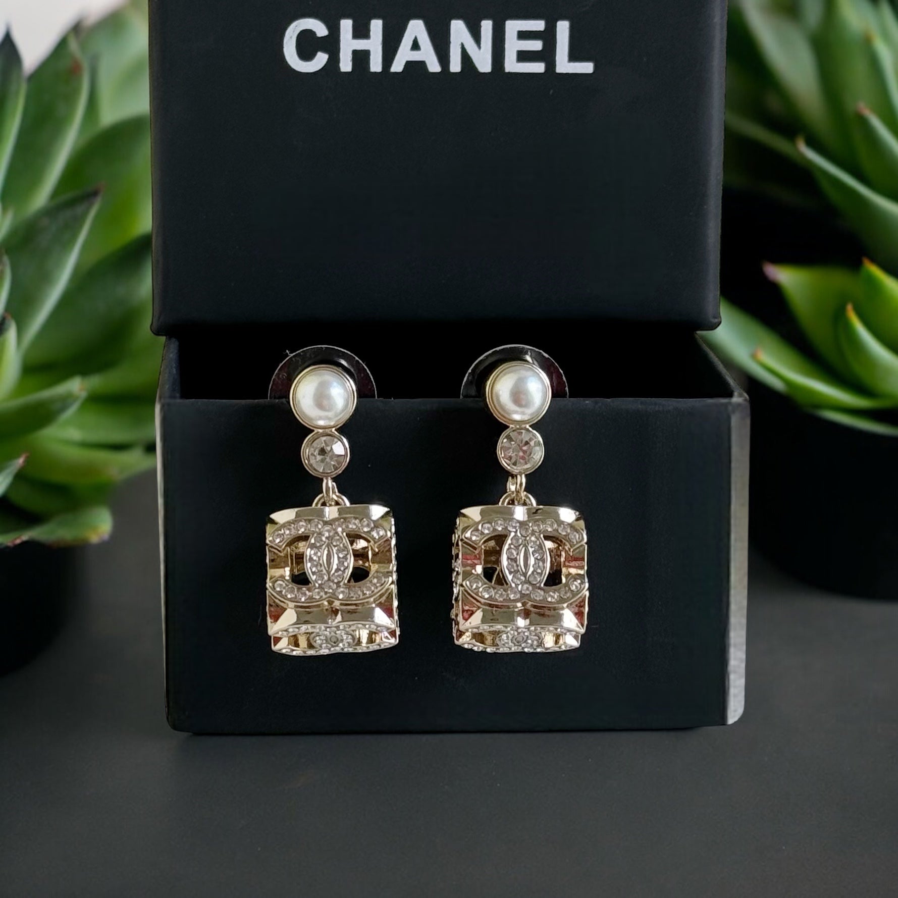 Chanel Gorgeous Rare Post Earrings with stunning Gold Double C encrusted clear crystalsThese Chanel earrings feature a stunning gold double C design, encrusted with clear crystals and a faux pearl center. The rare and like-new condition is reflected in th