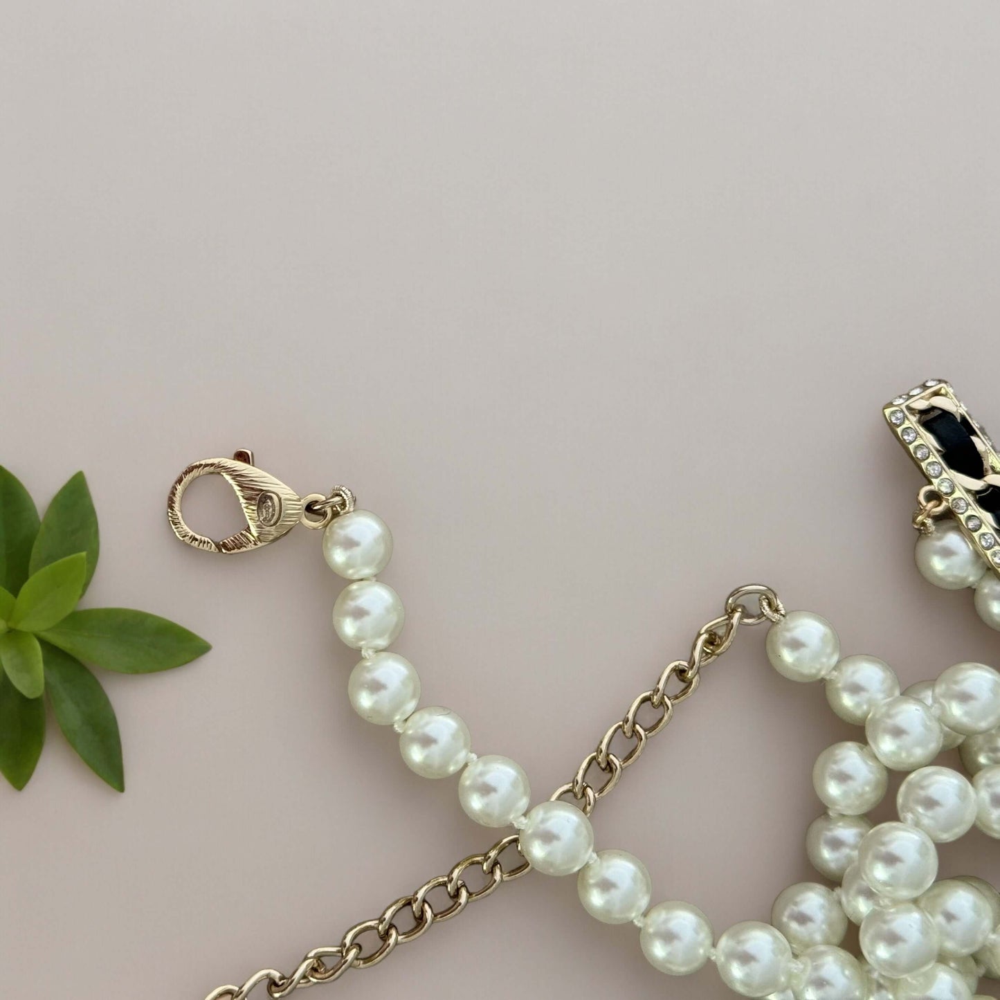 Chanel Knotted Pearl No.5 CC Sweater NecklaceIndulge in this gorgeous necklace adorned with a hand knotted pearl, Number 5 Chanel perfume charm, and sparkling crystals. The playful CC logo adds a touch of gold to the elegant black leather. Perfect for add My Mama Found What 