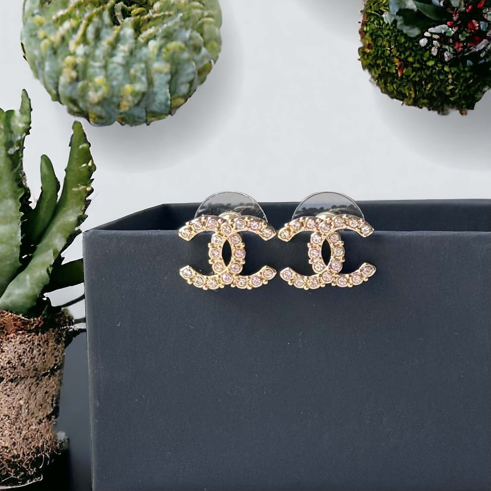 Chanel Lighter Gold Smaller Double C with round clear crystals earringsAccessorize with these lightweight Chanel Gold Double C earrings, featuring clear round crystals that add subtle sparkle to any outfit. Versatile for any occasion, these elegant earrin