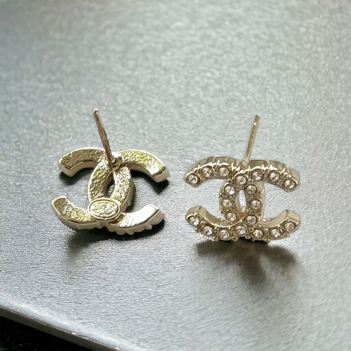 Chanel Lighter Gold Smaller Double C with round clear crystals earringsAccessorize with these lightweight Chanel Gold Double C earrings, featuring clear round crystals that add subtle sparkle to any outfit. Versatile for any occasion, these elegant earrin
