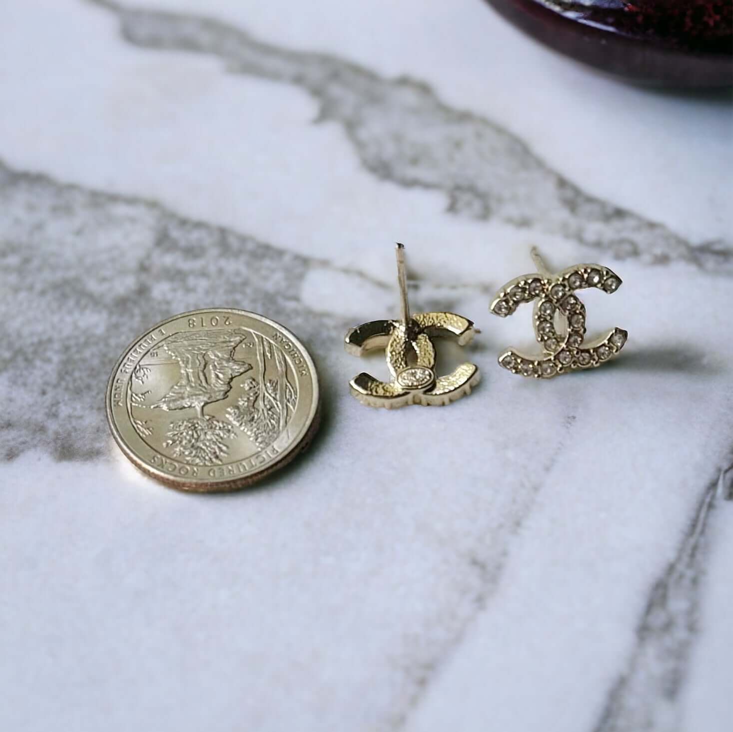 Chanel Lighter Gold Smaller Double C with round clear crystals earringsAccessorize with these lightweight Chanel Gold Double C earrings, featuring clear round crystals that add subtle sparkle to any outfit. Versatile for any occasion, these elegant earrin