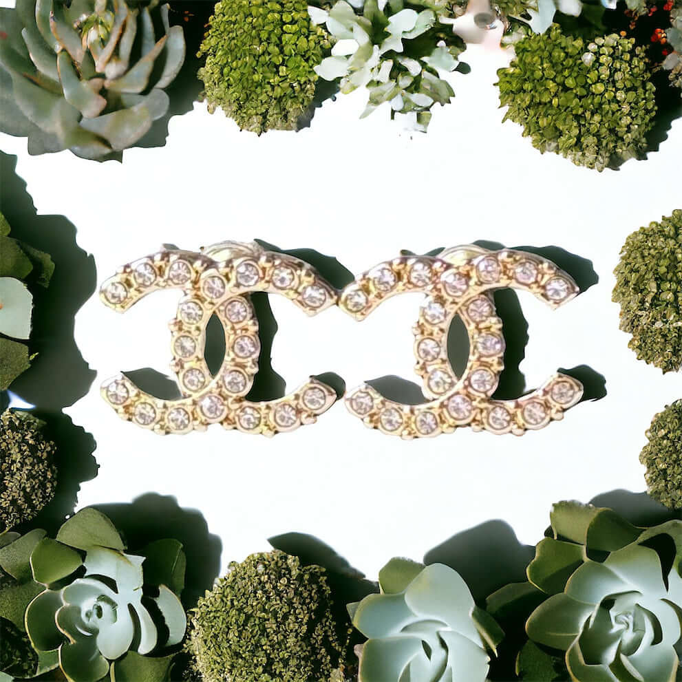 Chanel Lighter Gold Smaller Double C with round clear crystals earringsAccessorize with these lightweight Chanel Gold Double C earrings, featuring clear round crystals that add subtle sparkle to any outfit. Versatile for any occasion, these elegant earrin My Mama Found What 
