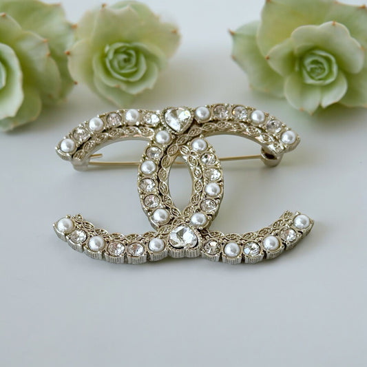 Chanel Paler Gold Double C Pearls Crystals Dressy BroochRare Style Like New Gorgeous Chanel Paler Gold Double C Pearls & Crystals Has a heart like shaped crystal in the center of both top and bottom . Faux Pearls Clear Crystals Strass Gold Plated Comes wi My Mama Found What 