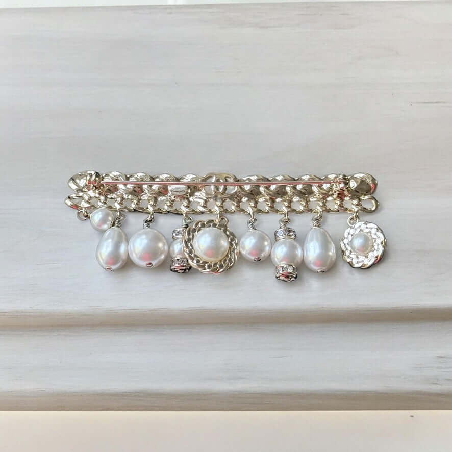 Chanel Rare Lighter Gold Long with Various Dangling Charms Brooch Pin 21 PIntroducing an elegant and rare brooch from Chanel, the Rare Lighter Gold Long Brooch with Various Dangling Charms! Accented with faux pearls and crystals, this brooch features a mi My Mama Found What 