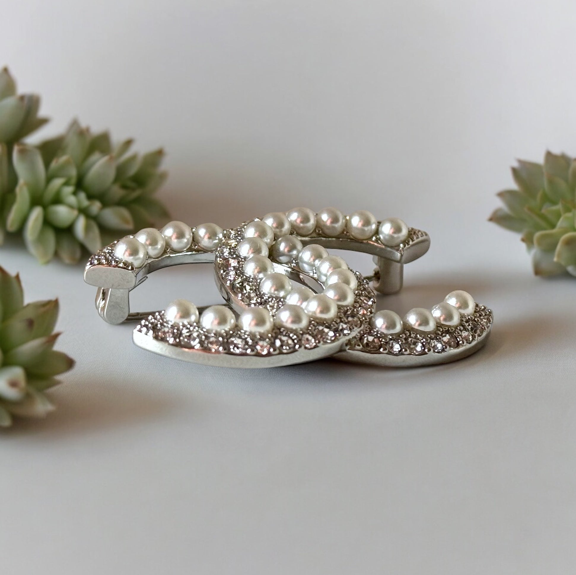 Chanel Silver Double C Brooch With Pearls & Crystals PinClassic , Clean Lines , minimalistic , elegant yet updated on trend Purchased at an Estate Sale Silver Double C with (faux) gorgeous pearls and clear crystals . In Like New Condition Free from dings
