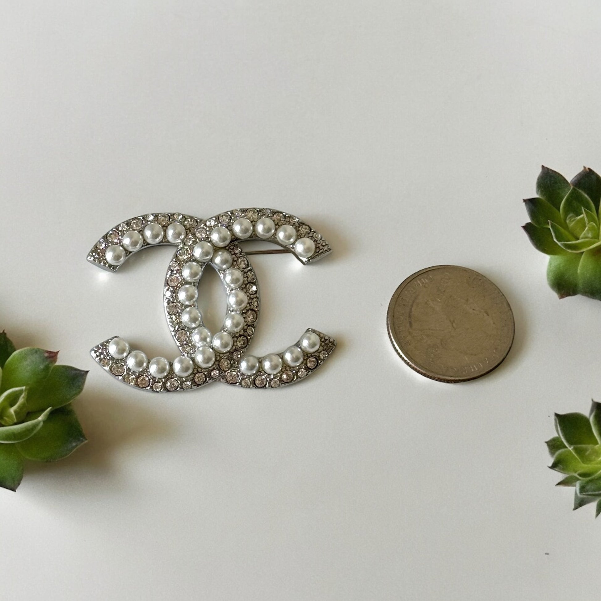 Chanel Silver Double C Brooch With Pearls & Crystals PinClassic , Clean Lines , minimalistic , elegant yet updated on trend Purchased at an Estate Sale Silver Double C with (faux) gorgeous pearls and clear crystals . In Like New Condition Free from dings