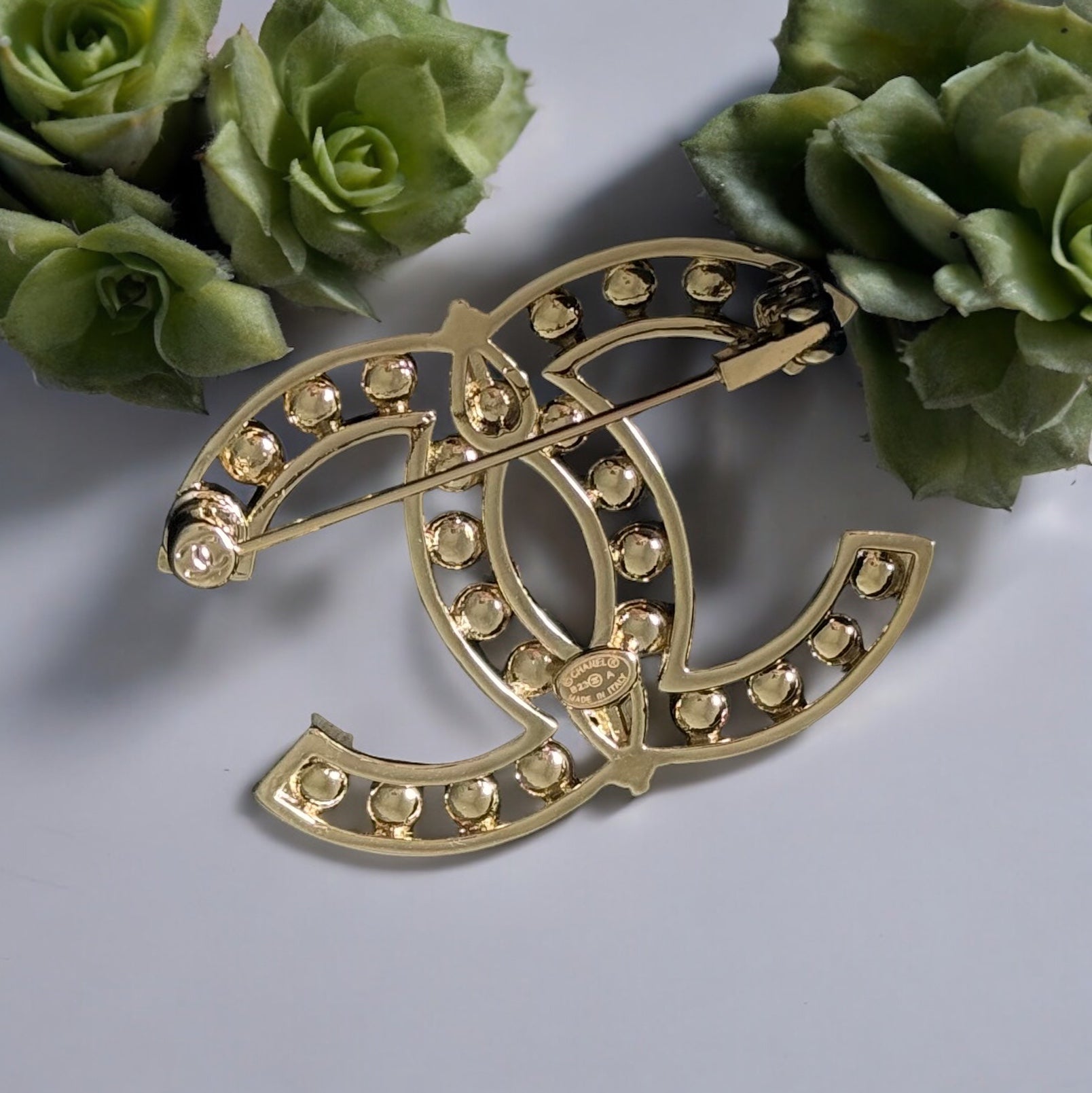 Chanel Strass Double C Cut Out with Clear Crystals Brooch Pin B23 ATransform any outfit into a statement piece with the Chanel Gold Double C brooch. Made in Italy, this brooch features bright clear crystals in Coco Chanel's signature cut-out design. Perfe