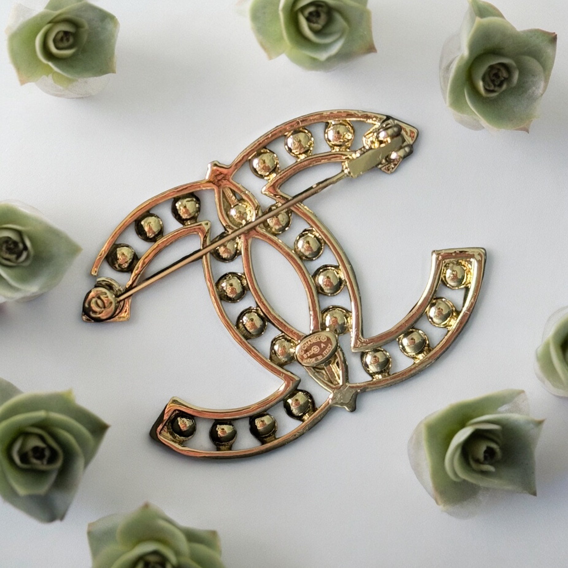 Chanel Strass Double C Cut Out with Clear Crystals Brooch Pin B23 ATransform any outfit into a statement piece with the Chanel Gold Double C brooch. Made in Italy, this brooch features bright clear crystals in Coco Chanel's signature cut-out design. Perfe