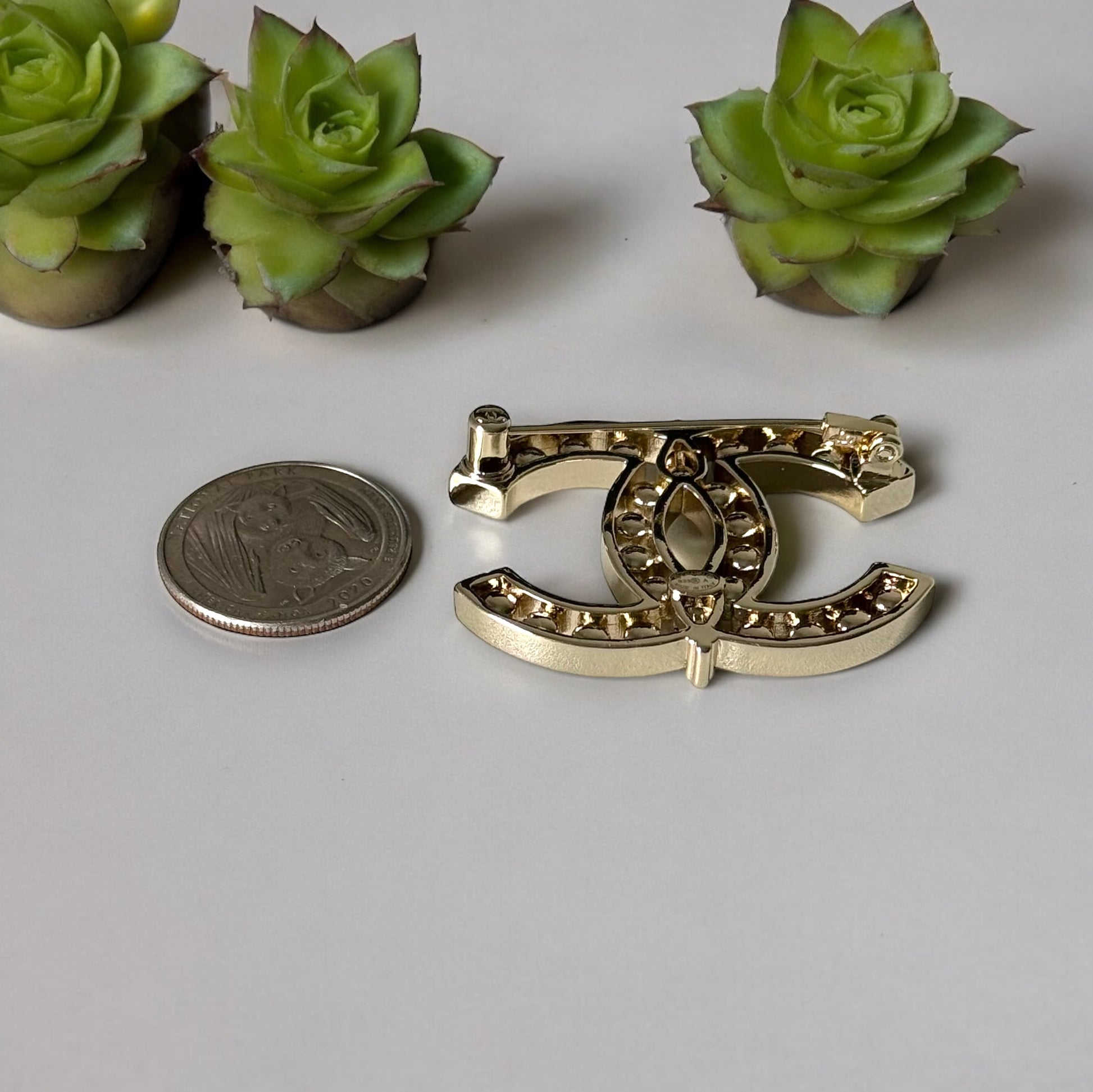 Chanel Strass Double C Cut Out with Clear Crystals Brooch Pin B23 ATransform any outfit into a statement piece with the Chanel Gold Double C brooch. Made in Italy, this brooch features bright clear crystals in Coco Chanel's signature cut-out design. Perfe