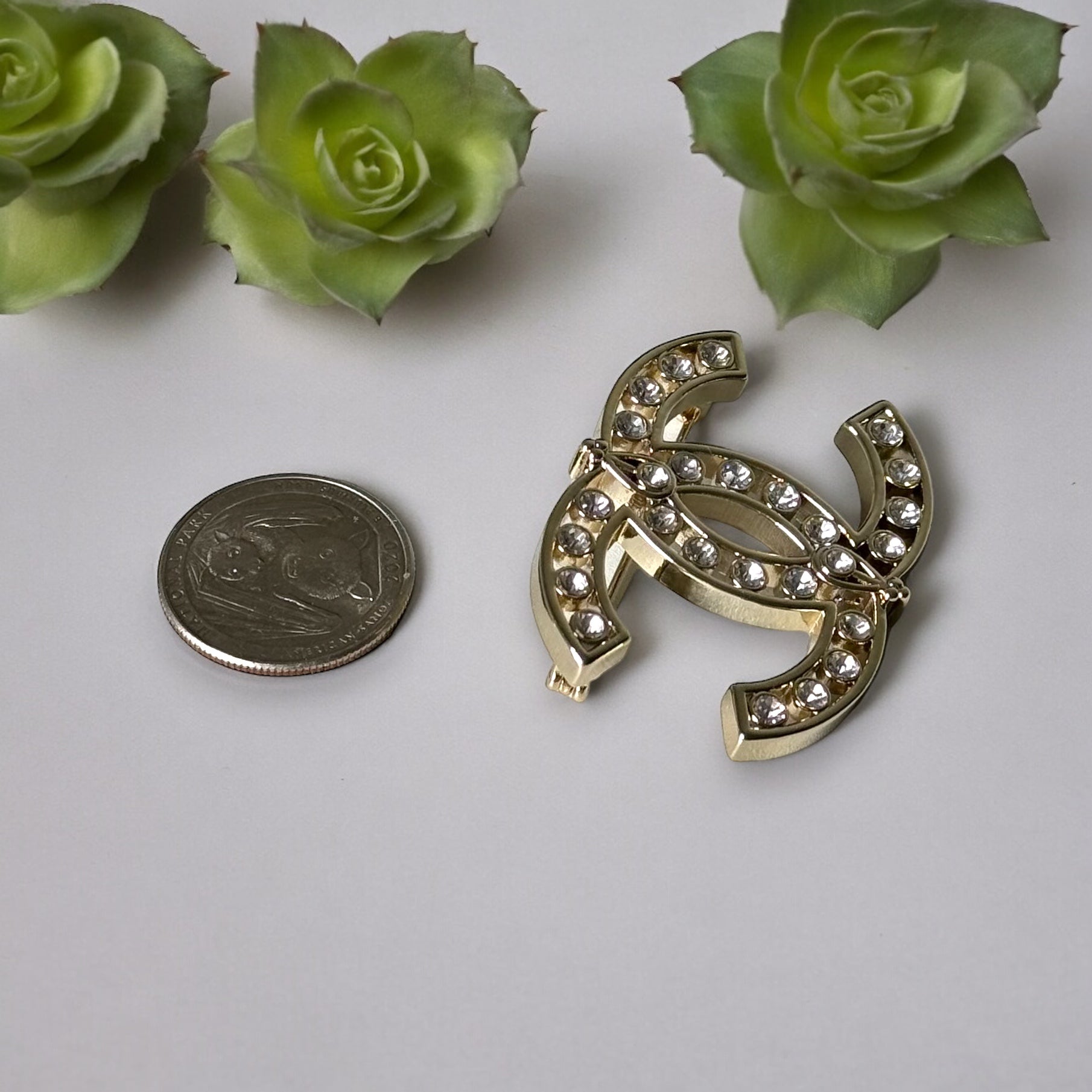 Chanel Strass Double C Cut Out with Clear Crystals Brooch Pin B23 ATransform any outfit into a statement piece with the Chanel Gold Double C brooch. Made in Italy, this brooch features bright clear crystals in Coco Chanel's signature cut-out design. Perfe
