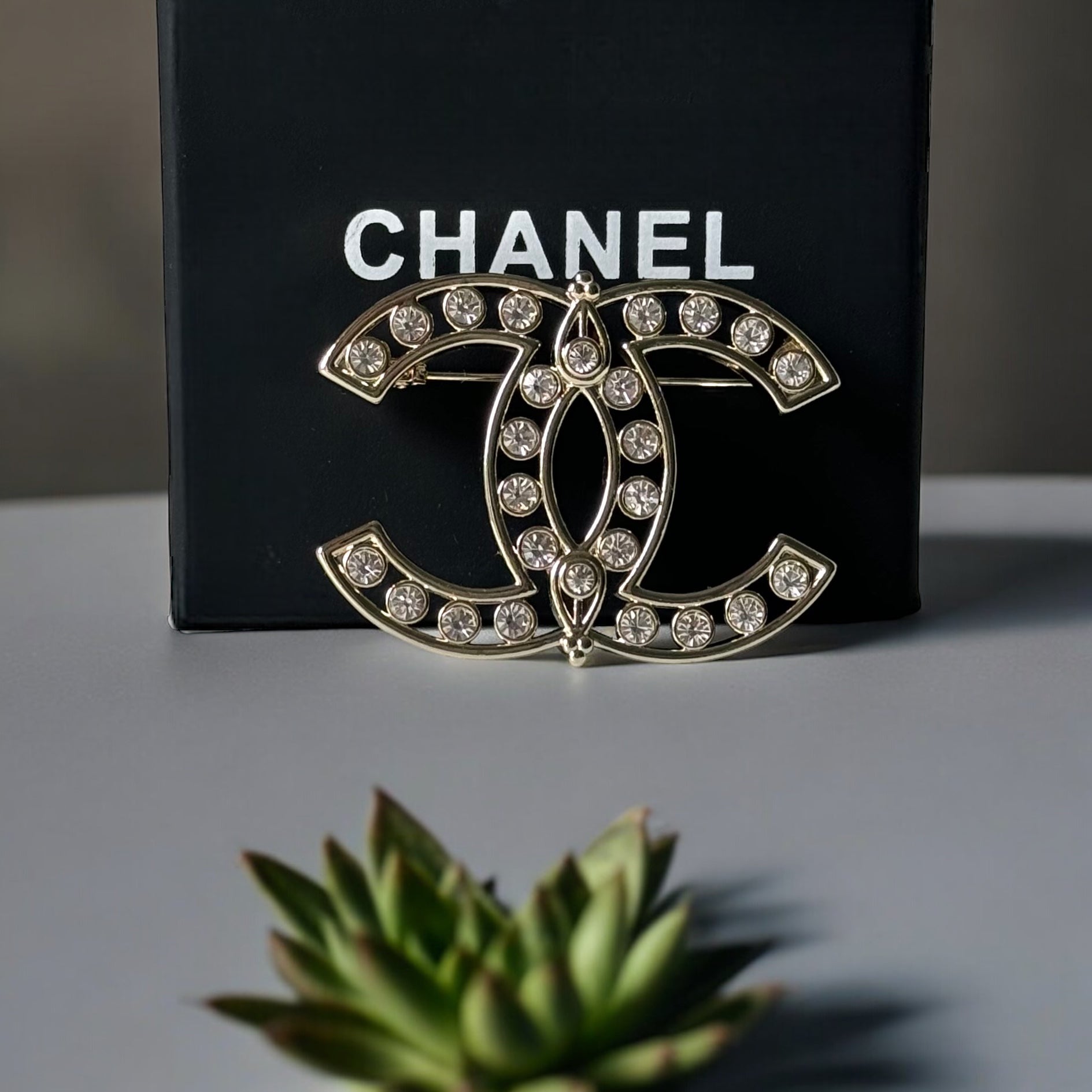 Chanel Strass Double C Cut Out with Clear Crystals Brooch Pin B23 ATransform any outfit into a statement piece with the Chanel Gold Double C brooch. Made in Italy, this brooch features bright clear crystals in Coco Chanel's signature cut-out design. Perfe