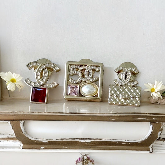 Chanel Strass Lighter Gold Set of 3 Crystal Encrusted Double C Cut Out Brooch PinsEmbrace daring style with this set of 3 Chanel brooch pins. Each one is uniquely designed, with crystal encrusted C-cutouts in a striking gold tone. Add these to any outfit My Mama Found What 