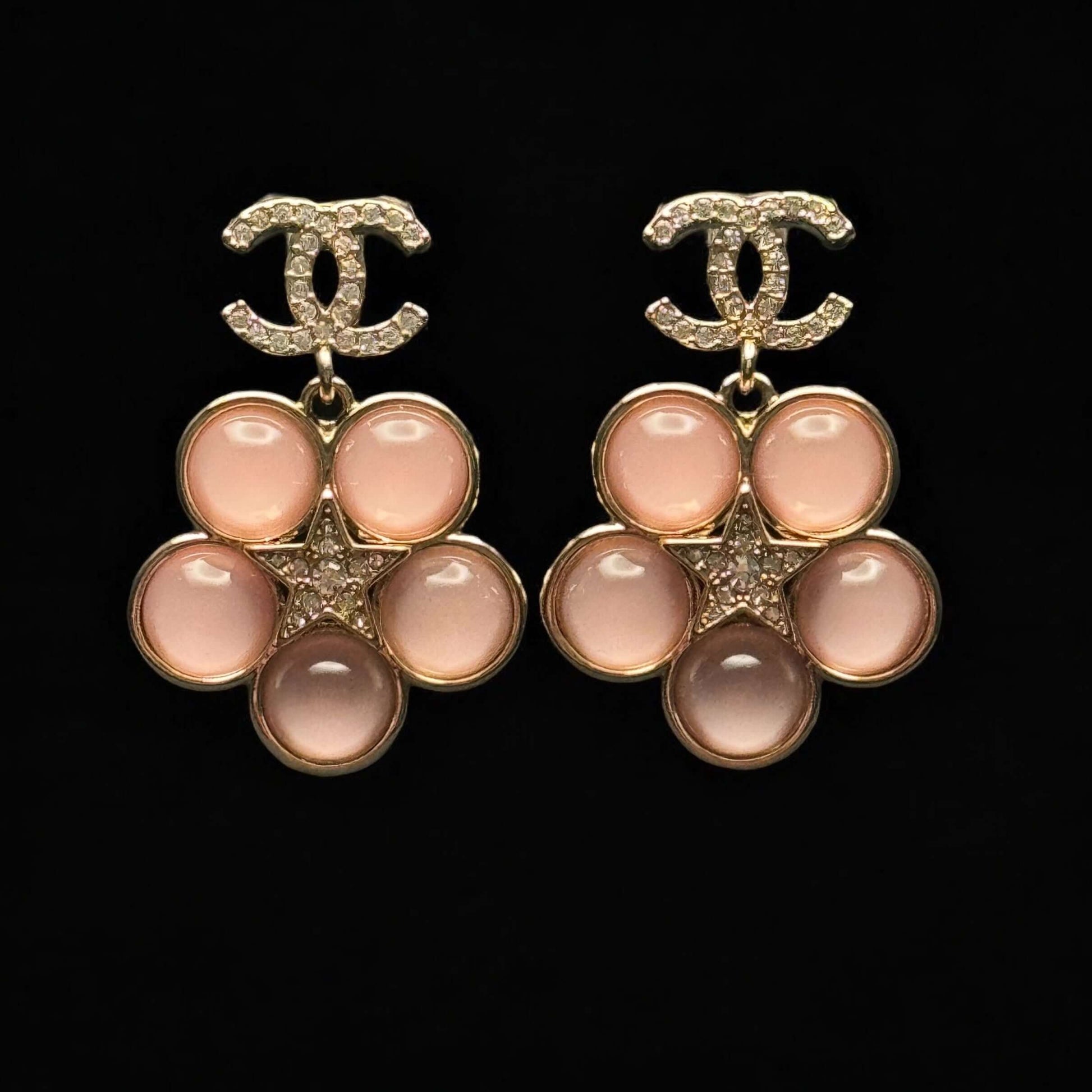 Authentic CHANEL CC Lighter Gold Stars Pink Dangle Earrings with floral design, pre-owned and in excellent condition.