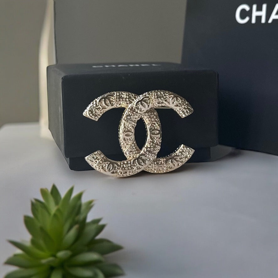 Chanel Gold Plated Textured Double C Brooch PinGorgeous , Ageless , Timeless , Extra Comes with the Chanel Box & Bag Add some whimsy to your outfit with this Chanel Gold Textured Double C Brooch Pin. This playful accessory features a unique textured desig