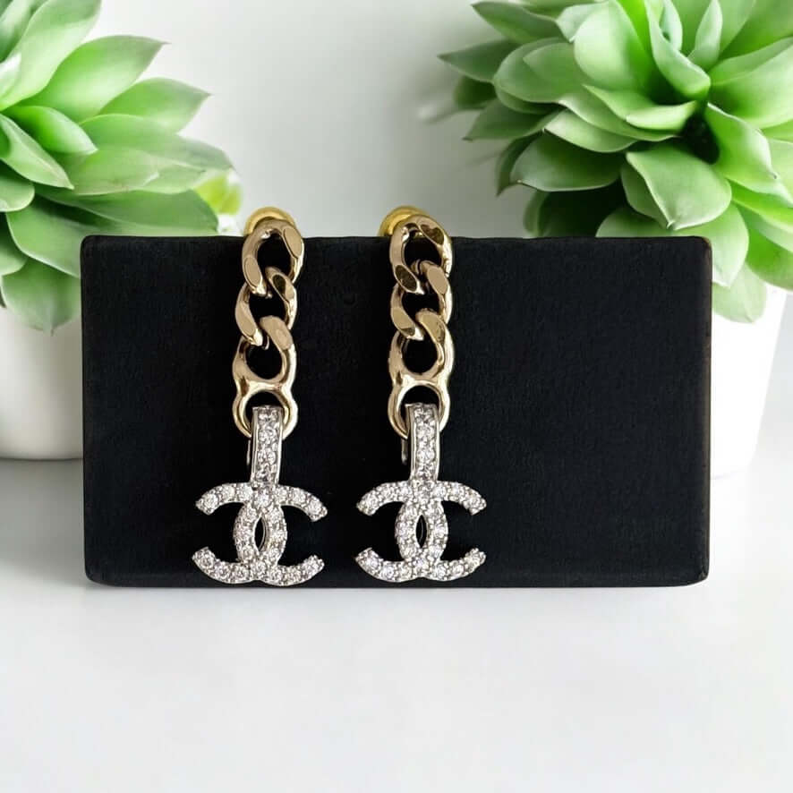 Stunning pre-owned Chanel CC Gold Chain Drop Earrings with crystal embellishments on a stylish display.