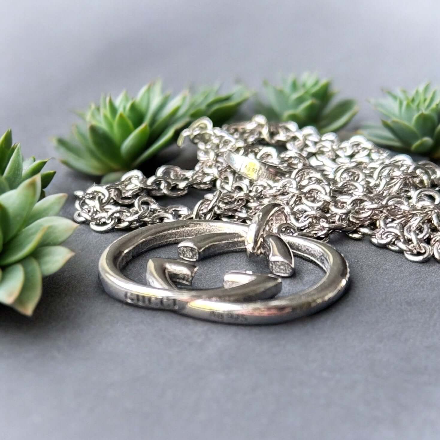 Gucci New Sterling Double G Marmont Pendant Necklace"Take risks with the Gucci New Sterling Double G Marmont Pendant Necklace. Made of stunning sterling silver, the minimalistic design features a bold Double G charm, creating a statement piece for any out