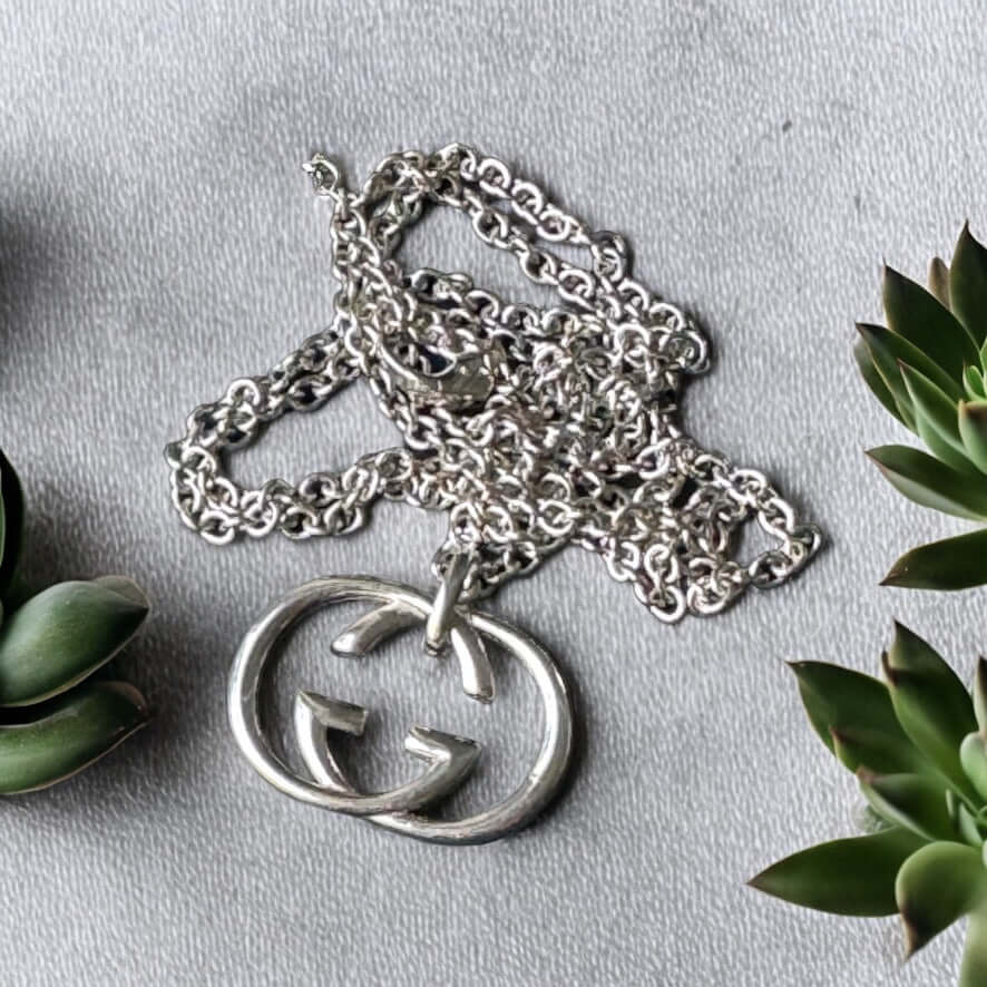 Gucci New Sterling Double G Marmont Pendant Necklace"Take risks with the Gucci New Sterling Double G Marmont Pendant Necklace. Made of stunning sterling silver, the minimalistic design features a bold Double G charm, creating a statement piece for any out