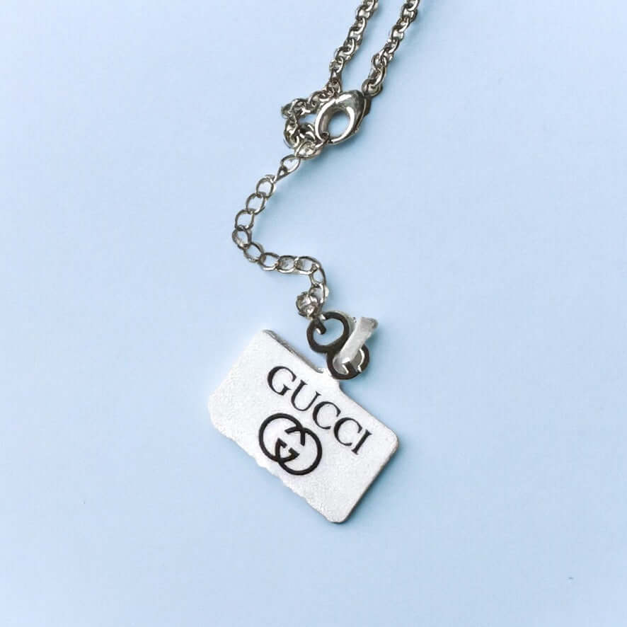 Gucci New Sterling Double G Marmont Pendant Necklace"Take risks with the Gucci New Sterling Double G Marmont Pendant Necklace. Made of stunning sterling silver, the minimalistic design features a bold Double G charm, creating a statement piece for any out