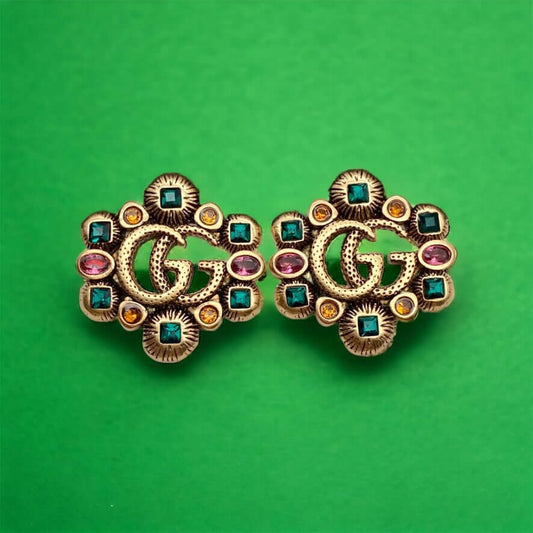Gucci Stunning Antique Gold (ish) Tone with various colors & shapes crystals Post EarringsAdd some sparkle to your life with these Gucci Stunning Antique Gold (ish) Tone Post Earrings! Featuring the iconic Gucci Double G Marmont Line, these earrings are a
