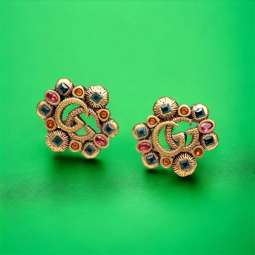 Gucci Stunning Antique Gold (ish) Tone with various colors & shapes crystals Post EarringsAdd some sparkle to your life with these Gucci Stunning Antique Gold (ish) Tone Post Earrings! Featuring the iconic Gucci Double G Marmont Line, these earrings are a